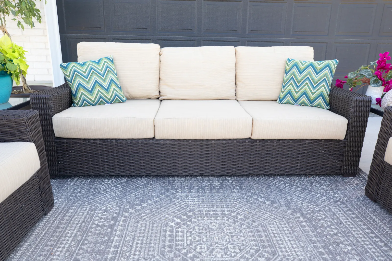 outdoor furniture on a patio with a rug
