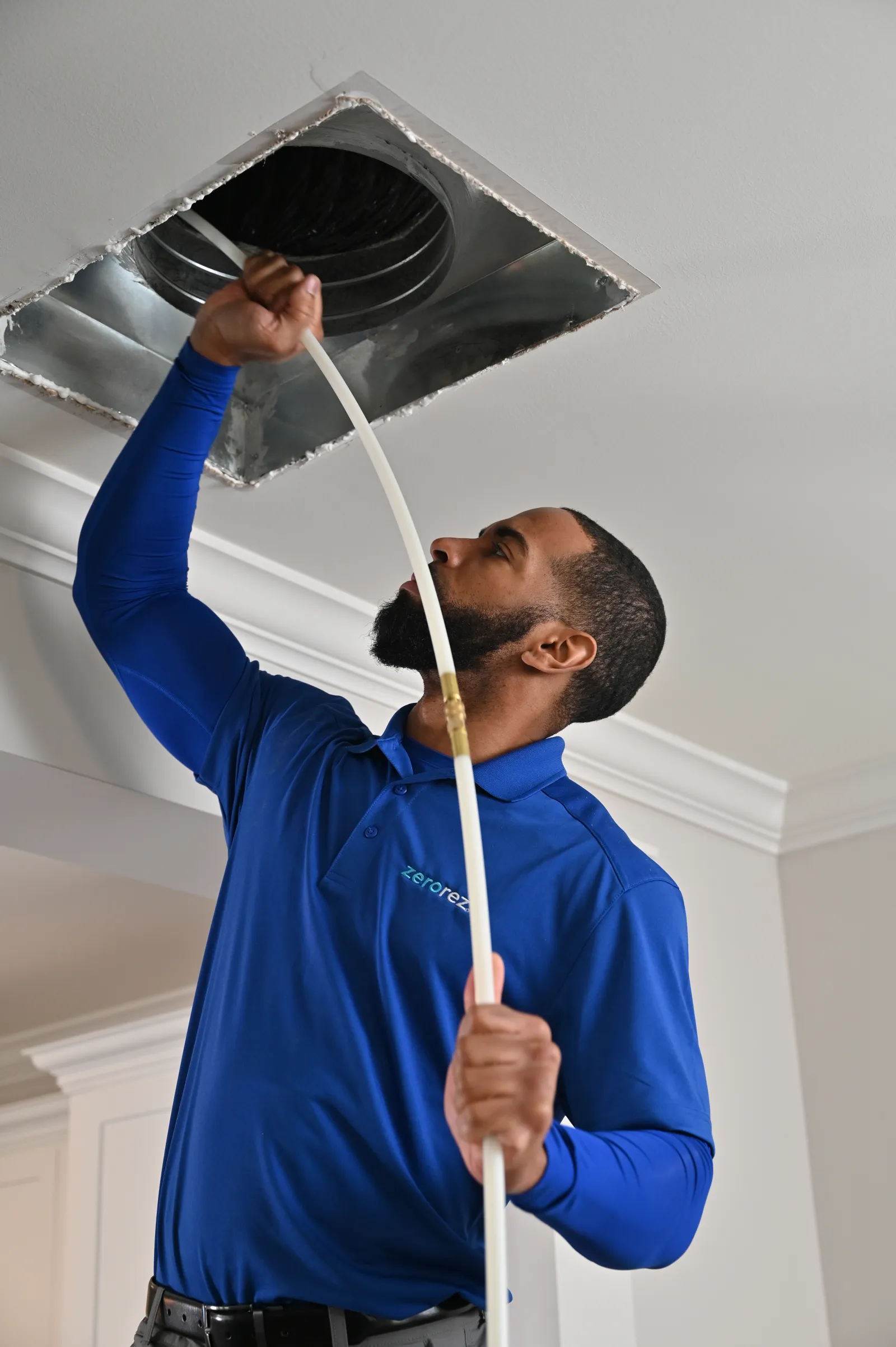 man cleaning air ducts in a home